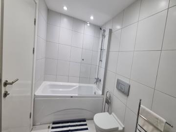 fully-tiled-bathroom-with-bath-and-shower