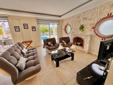 Beautiful Fethiye Property For Sale Near The Beach - Stunning lounge with a fireplace