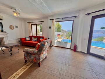 An Idyllic Detached Kalkan Villa For Sale - Living space with sun terrace and pool access