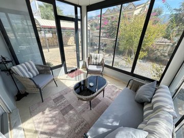 A Detached Immaculate Villa For Sale In Akbuk - Enclosed balcony from the kitchen/ winter garden