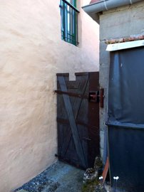 On the side of the house, there is a practical access gate